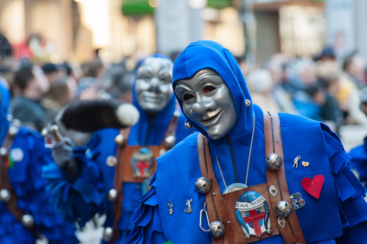 Home Vibrant carnival parade featuring participants in blue costumes and masks, showcasing cultural festivities.